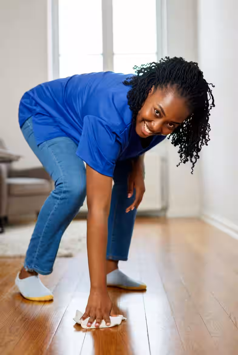 Housekeeper cleaning a floor during a professional house clean