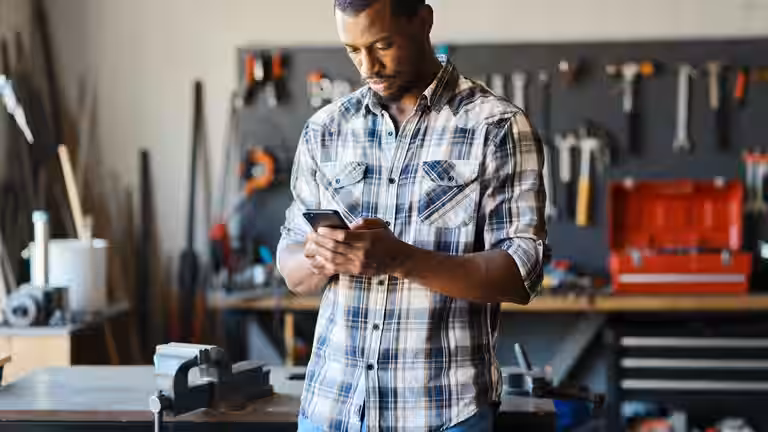 Tradesman checking his managed website on his phone