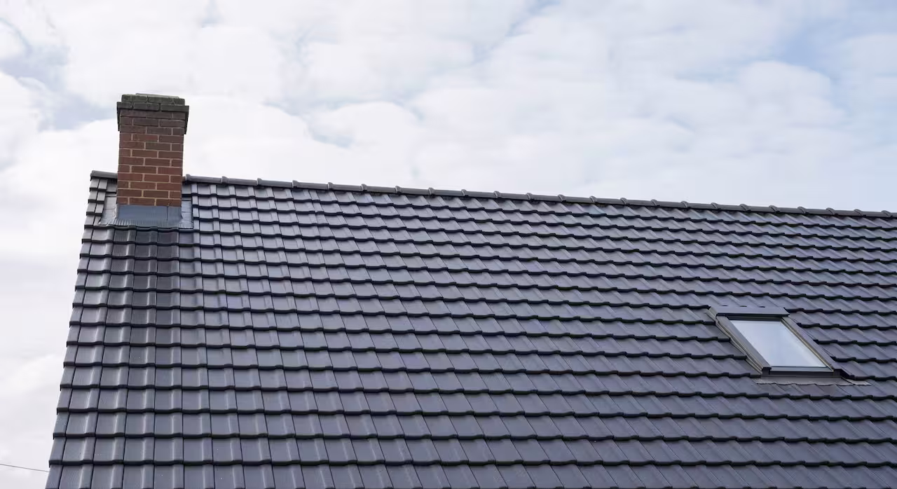 A completed new-build house roof with clean ridge tiles